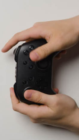 Vertical-Video-Overhead-Studio-Hands-Using-Playing-Video-Game-Controller-3